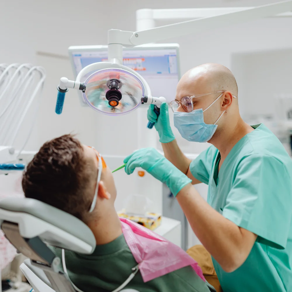 Oral and maxillofacial surgeon examining a patient during a surgical dental consultation