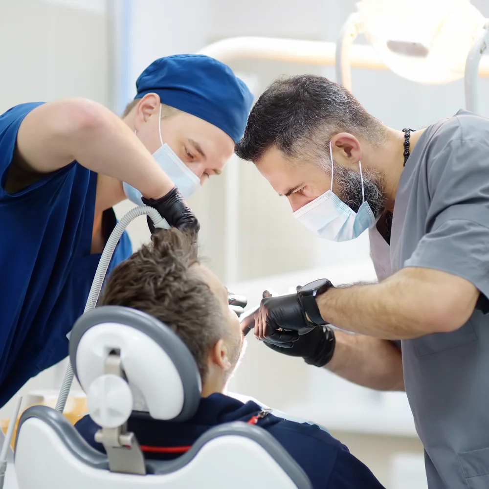 Dental team performing sedation dentistry procedure for stress-free and pain-managed dental treatment