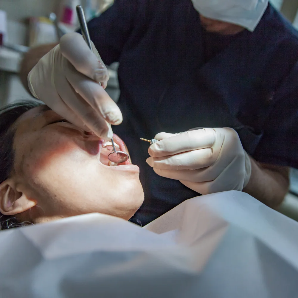 Oral surgeon performing a professional dental surgery procedure using specialized dental instruments