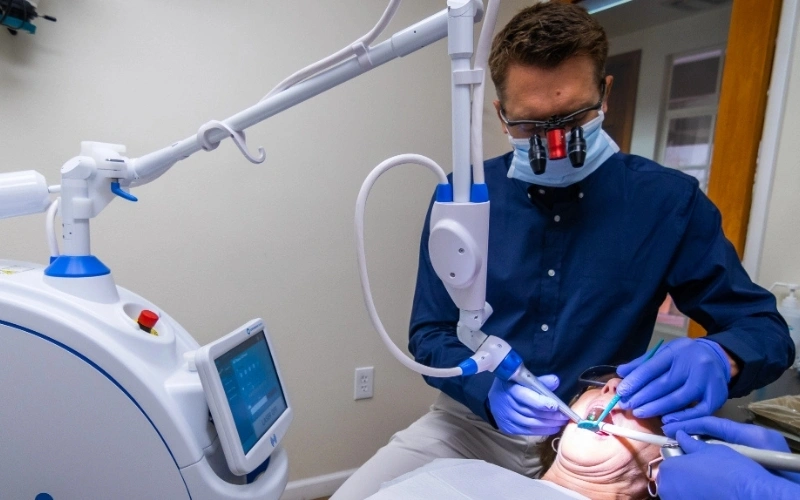 Dentist performing advanced Solea laser treatment for comfortable and efficient dental care